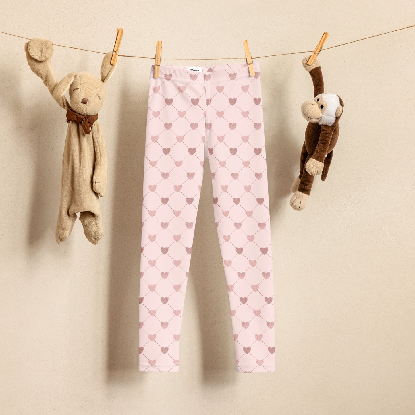 Image: Pink Hearts Pink Kids Leggings. These light pink leggings feature a trendy criss cross diamond pattern and pink hearts, perfect for toddlers and little girls. Available in sizes 2T-7, with matching adult yoga pants for stylish mommy and me outfits.