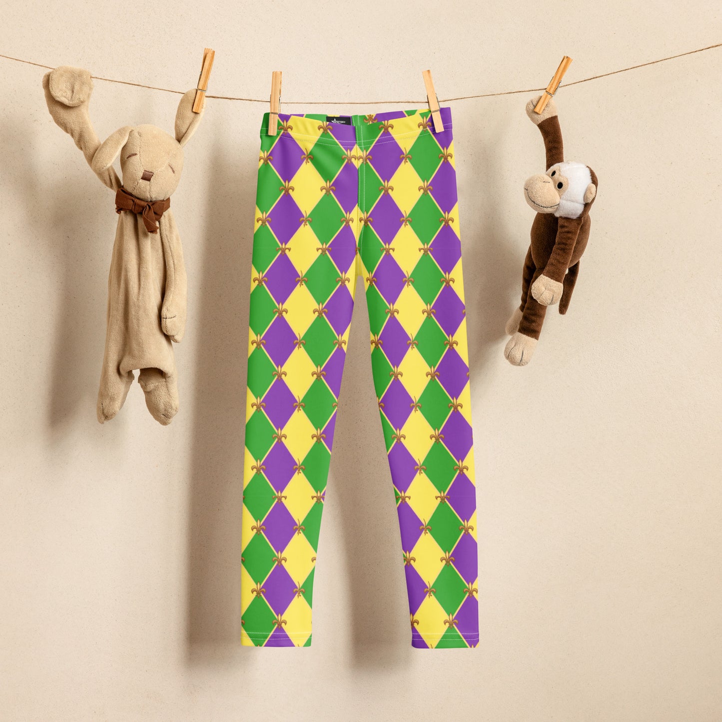 Image: Mardi Gras Kids Leggings, in sizes 2T-7. These Canival themed yoga pants feature a gold, green and purple diamond pattern with a fleur de lis accent. Perfect attire for any New Orleans French Quarter parade, by jaecrece