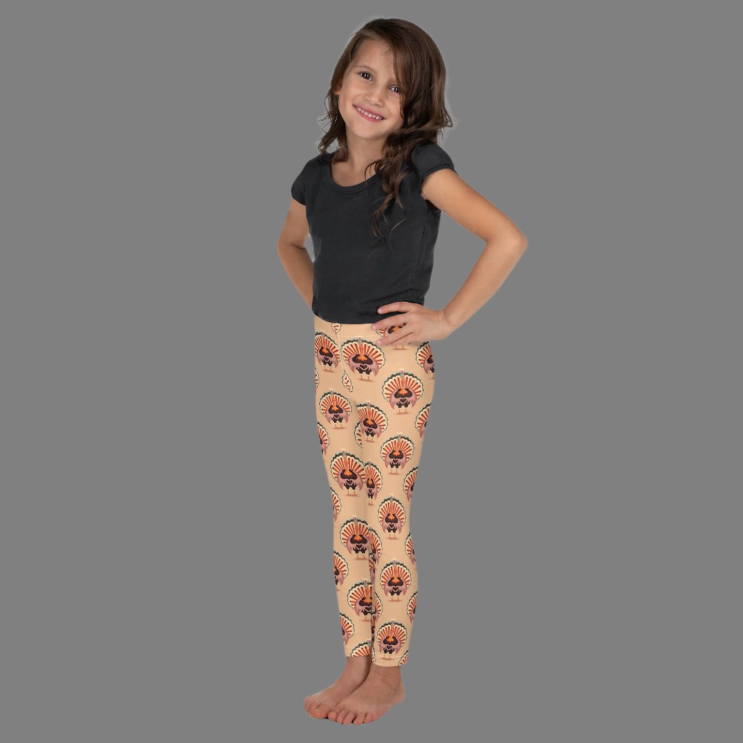 Thanksgiving Turkey Love Toddler leggings. These yoga pants are peach, and have a repeating pattern of turkeys showing the love sign with their hands. These girls child tights make a great gift, or a family matching outfit for the Turkey Trot! by jaecrece