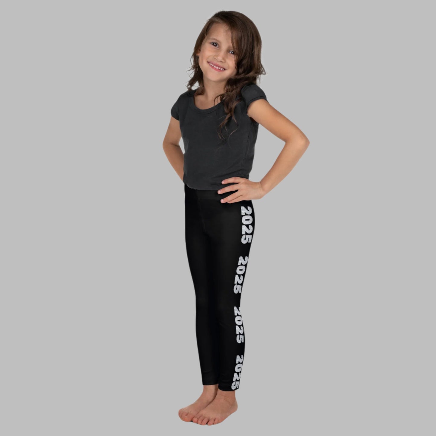 2025 Leggings for Happy New Year Party Celebration or a gift for graduating class of 2025. Black yoga pants have large repeating silver 2025 running down the outside of each leg. Tights are available in toddler and girls child sizes 2T-7, by jaecrece