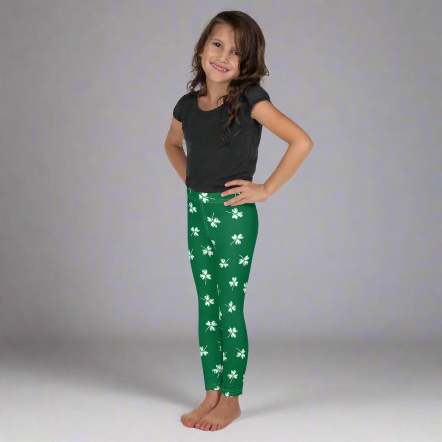 Image: Family Matching St Patricks Day Shamrock Leggings. Festive yoga pants with green background and white four leaf clovers. Available in sizes for toddler girls, teens, tweens, and women. Perfect for a St Pattys Day parade or fun run, by jaecrece