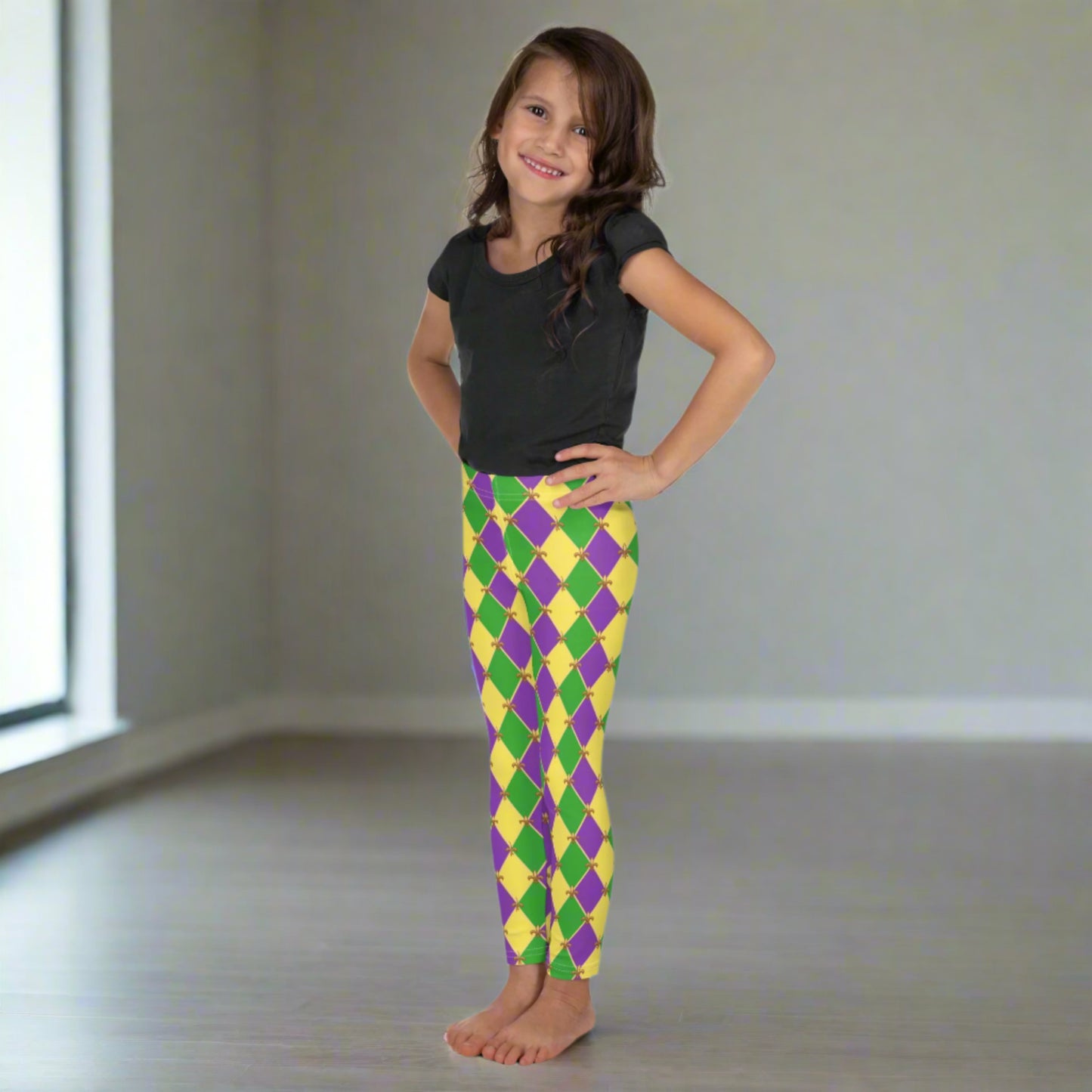 Image: Mardi Gras Kids Leggings, in sizes 2T-7. These Canival themed yoga pants feature a gold, green and purple diamond pattern with a fleur de lis accent. Perfect attire for any New Orleans French Quarter parade, by jaecrece