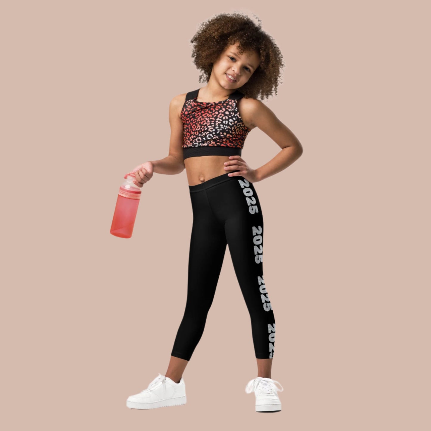 2025 Leggings for Happy New Year Party Celebration or a gift for graduating class of 2025. Black yoga pants have large repeating silver 2025 running down the outside of each leg. Tights are available in toddler and girls child sizes 2T-7, by jaecrece