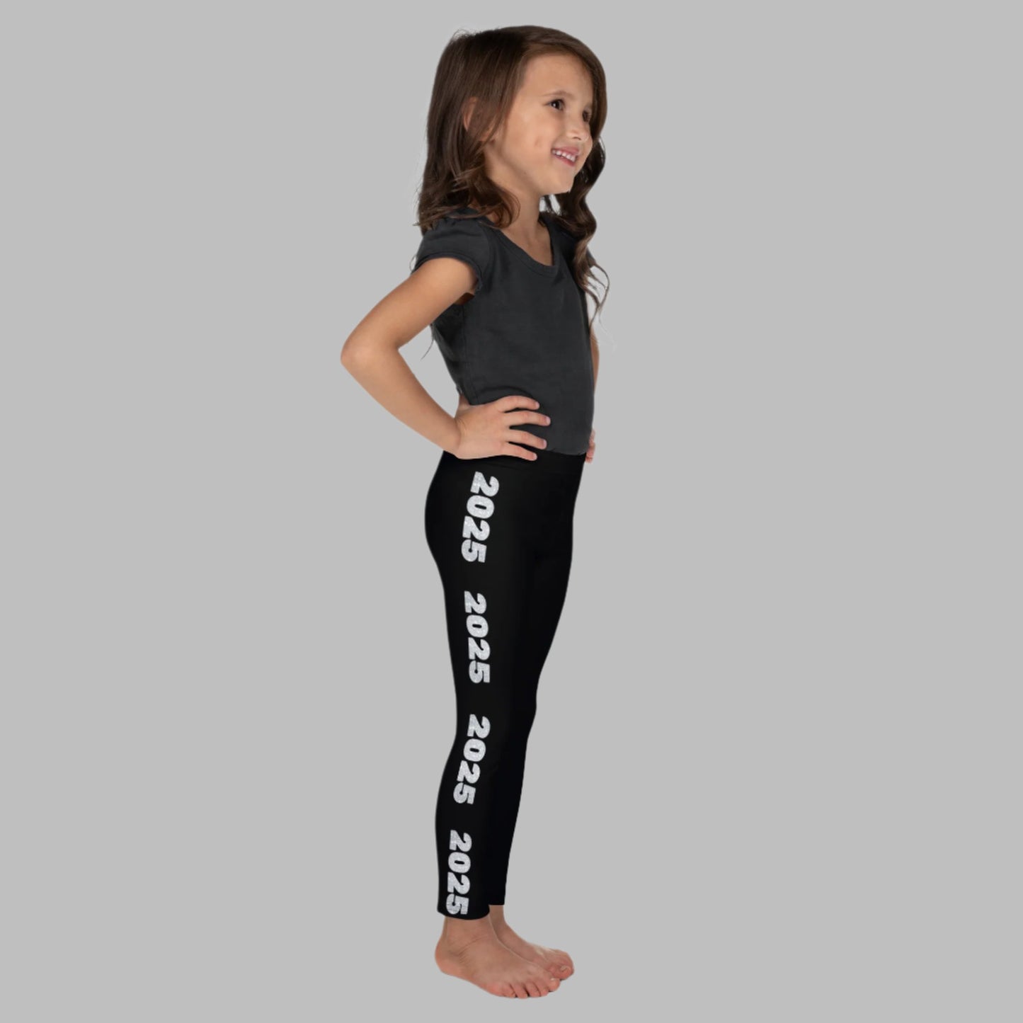 2025 Leggings for Happy New Year Party Celebration or a gift for graduating class of 2025. Black yoga pants have large repeating silver 2025 running down the outside of each leg. Tights are available in toddler and girls child sizes 2T-7, by jaecrece