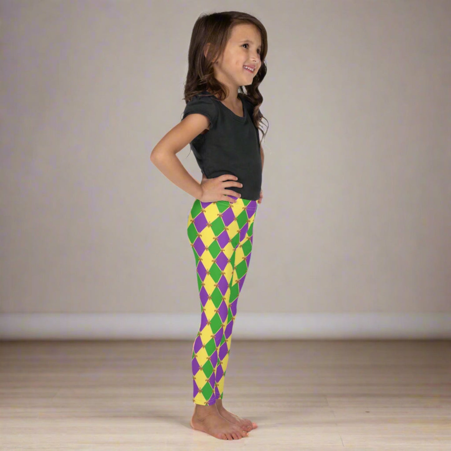 Image: Mardi Gras Kids Leggings, in sizes 2T-7. These Canival themed yoga pants feature a gold, green and purple diamond pattern with a fleur de lis accent. Perfect attire for any New Orleans French Quarter parade, by jaecrece