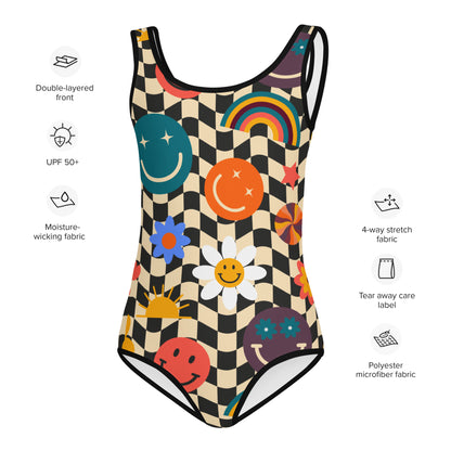 Smiley Face Checkerboard Girls One Piece Bathing Suit. This cute retro swimsuit features a black and khaki checkerboard background, with smiley face, rainbow and daisy graphics. In toddler and girls sizes, 2T-7. by jaecrece.com