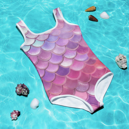 Image: Mermaid One Piece Swimsuit for Girls. This bathing suit is available in sizes 2T-7. It features mermaid scales in shades of pink, purple, blue and white, by jaecrece