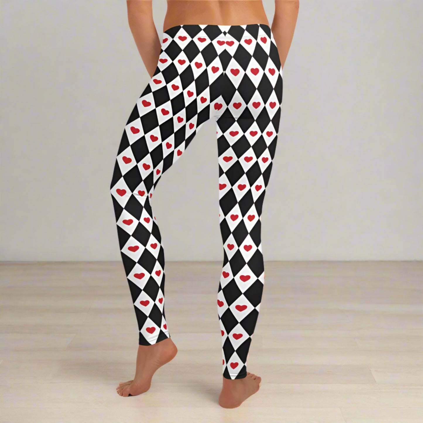 Image: Harlequin Love Ladies Leggings. These yoga tights have a black and white checker/ diamond pattern with a red heart accent, the perfect leggings for valentines day or a Queen of Hearts costume, by jaecrece