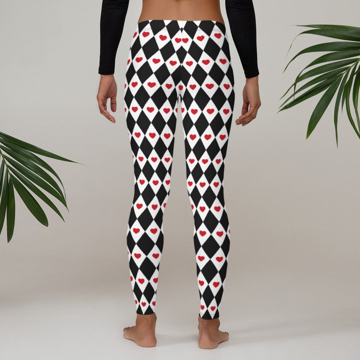 Image: Harlequin Love Ladies Leggings. These yoga tights have a black and white checker/ diamond pattern with a red heart accent, the perfect leggings for valentines day or a Queen of Hearts costume, by jaecrece