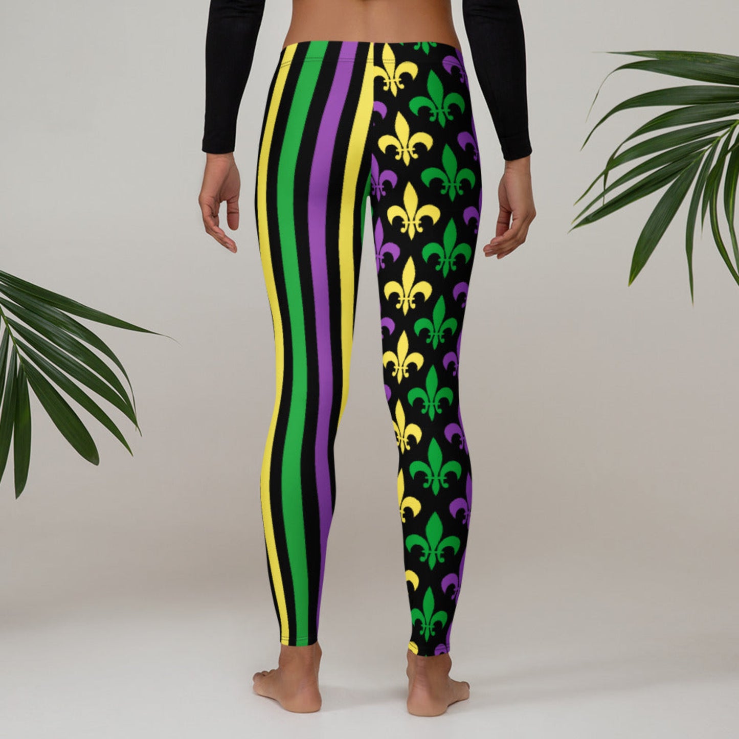 Alt text: Mardi Gras leggings for toddler girls, tweens, and women. Featuring a black background, one leg has bold gold, green, and purple stripes, while the other showcases a fleur-de-lis pattern. Perfect for celebrating New Orleans style with festive flair.