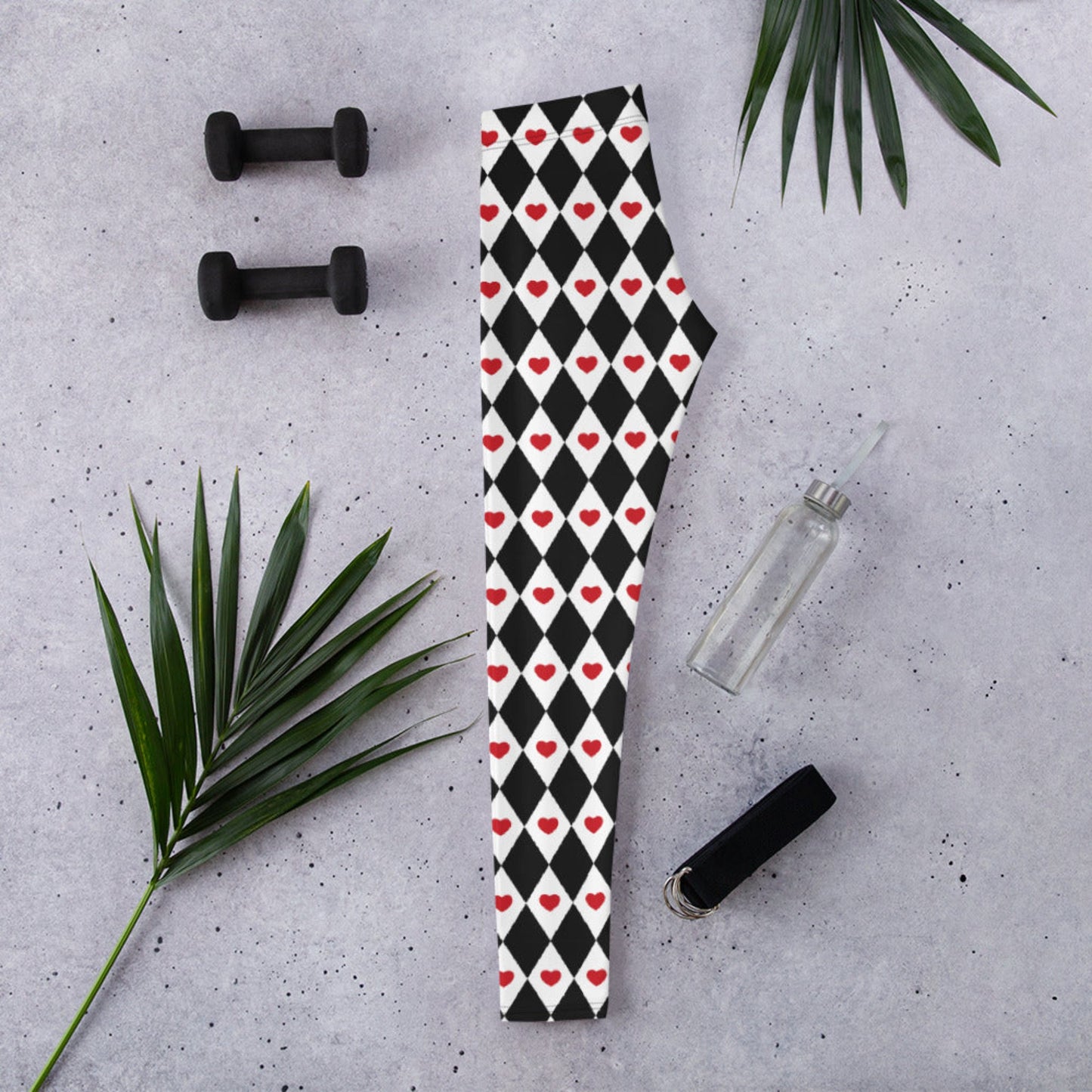 Image: Harlequin Love Ladies Leggings. These yoga tights have a black and white checker/ diamond pattern with a red heart accent, the perfect leggings for valentines day or a Queen of Hearts costume, by jaecrece