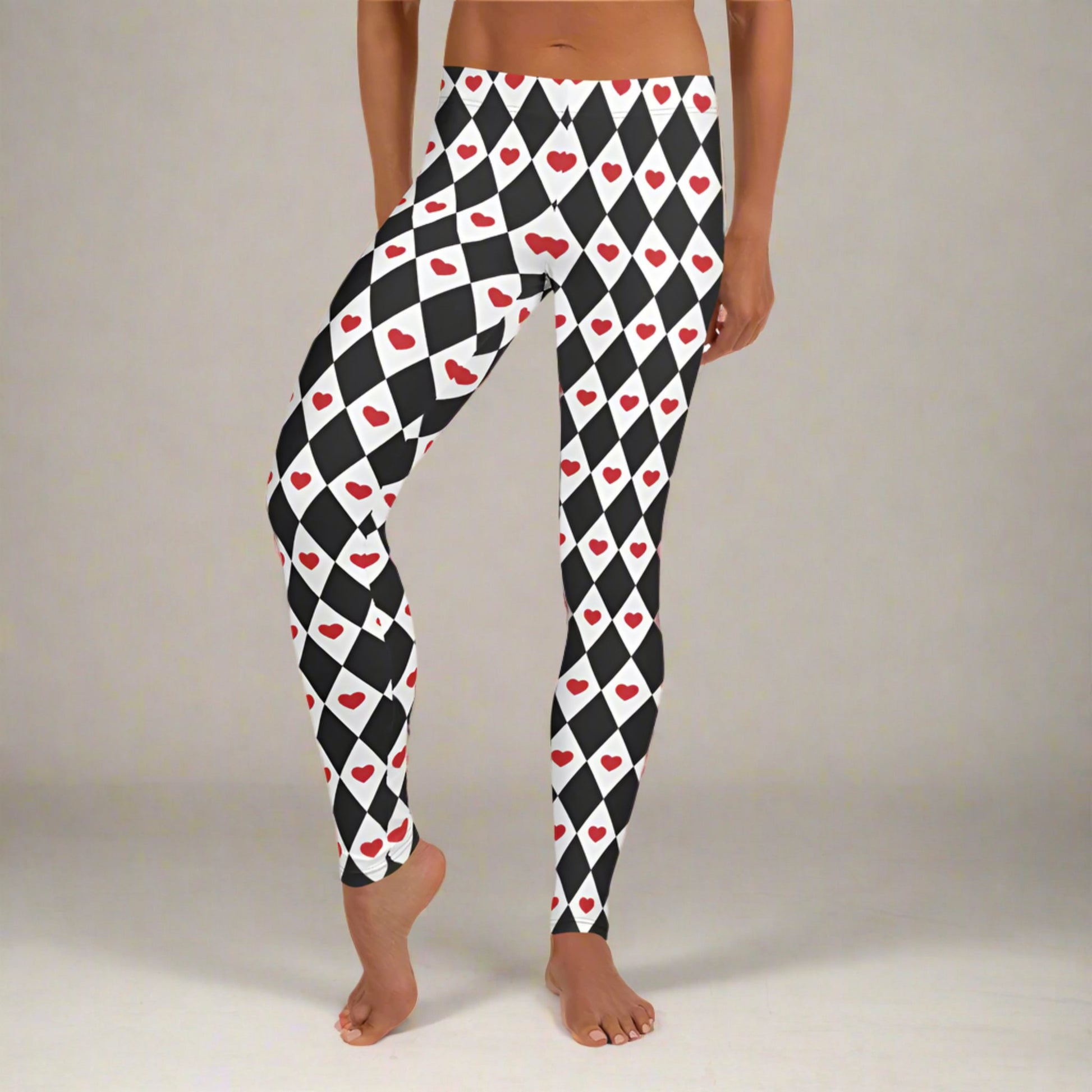 Image: Harlequin Love Ladies Leggings. These yoga tights have a black and white checker/ diamond pattern with a red heart accent, the perfect leggings for valentines day or a Queen of Hearts costume, by jaecrece