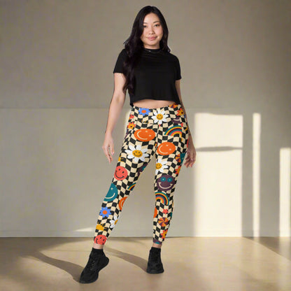 Smiley Face Checkerboard Adult Leggings. These cute retro leggings feature a black and khaki checkerboard background, with smiley face, rainbow and daisy graphics. In adult ladies sizes. by jaecrece.com - jaecrece