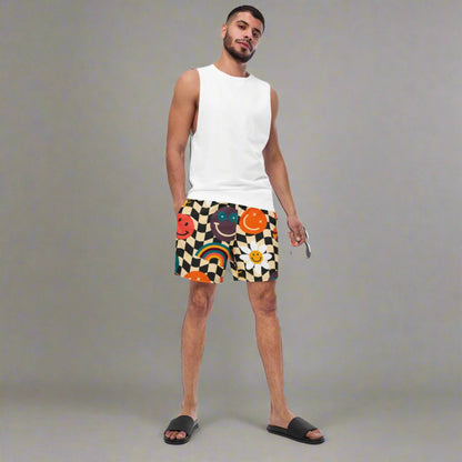 Smiley Face Checkerboard Mens Recycled Swim Trunks Family Matching Swim Wear Groovy Style Bathing Suit. These swim trunks feature a retro smiley face checkerboard pattern, with flowers and rainbows by jaecrece.com