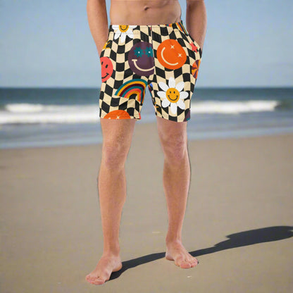 Smiley Face Checkerboard Mens Recycled Swim Trunks Family Matching Swim Wear Groovy Style Bathing Suit. These swim trunks feature a retro smiley face checkerboard pattern, with flowers and rainbows by jaecrece.com