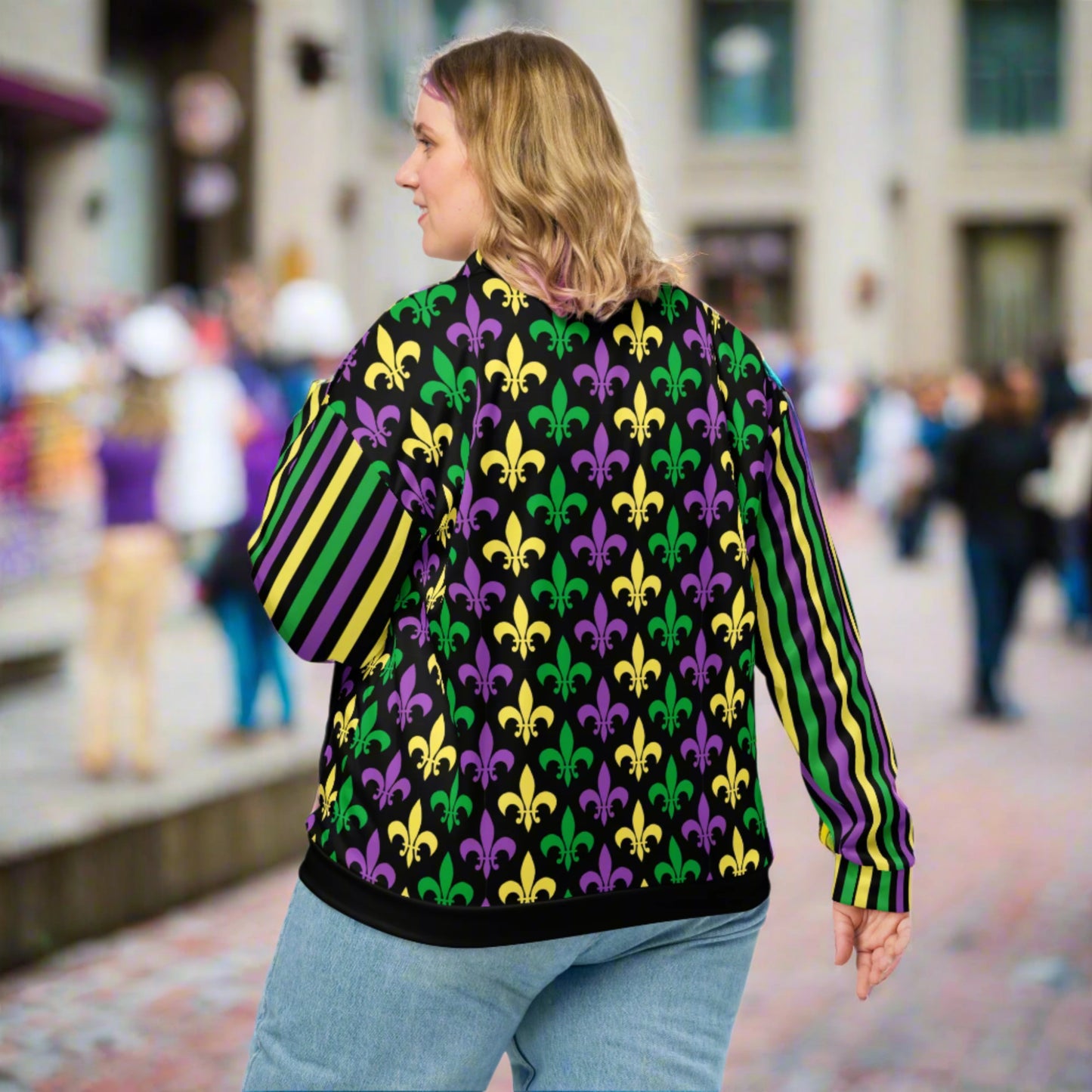 Image: Mardi Gras Unisex Bomber Jacket. This lightweight NOLA apparel is perfect for parades in the French Quarter, or Mardi Gras themed fun runs. It features a gold, green and purple fleur de lis pattern on the front and back, with gold, purple and green stripes going down each arm. Plus sizes available, by jaecrece