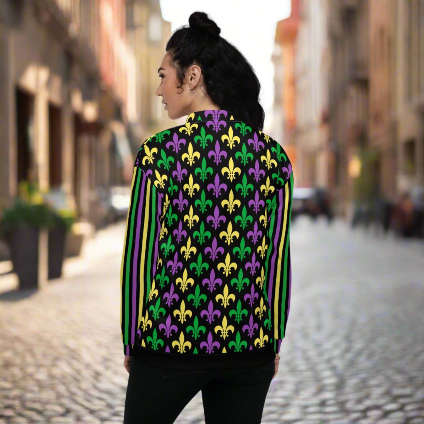 Image: Mardi Gras Unisex Bomber Jacket. This lightweight NOLA apparel is perfect for parades in the French Quarter, or Mardi Gras themed fun runs. It features a gold, green and purple fleur de lis pattern on the front and back, with gold, purple and green stripes going down each arm. Plus sizes available, by jaecrece