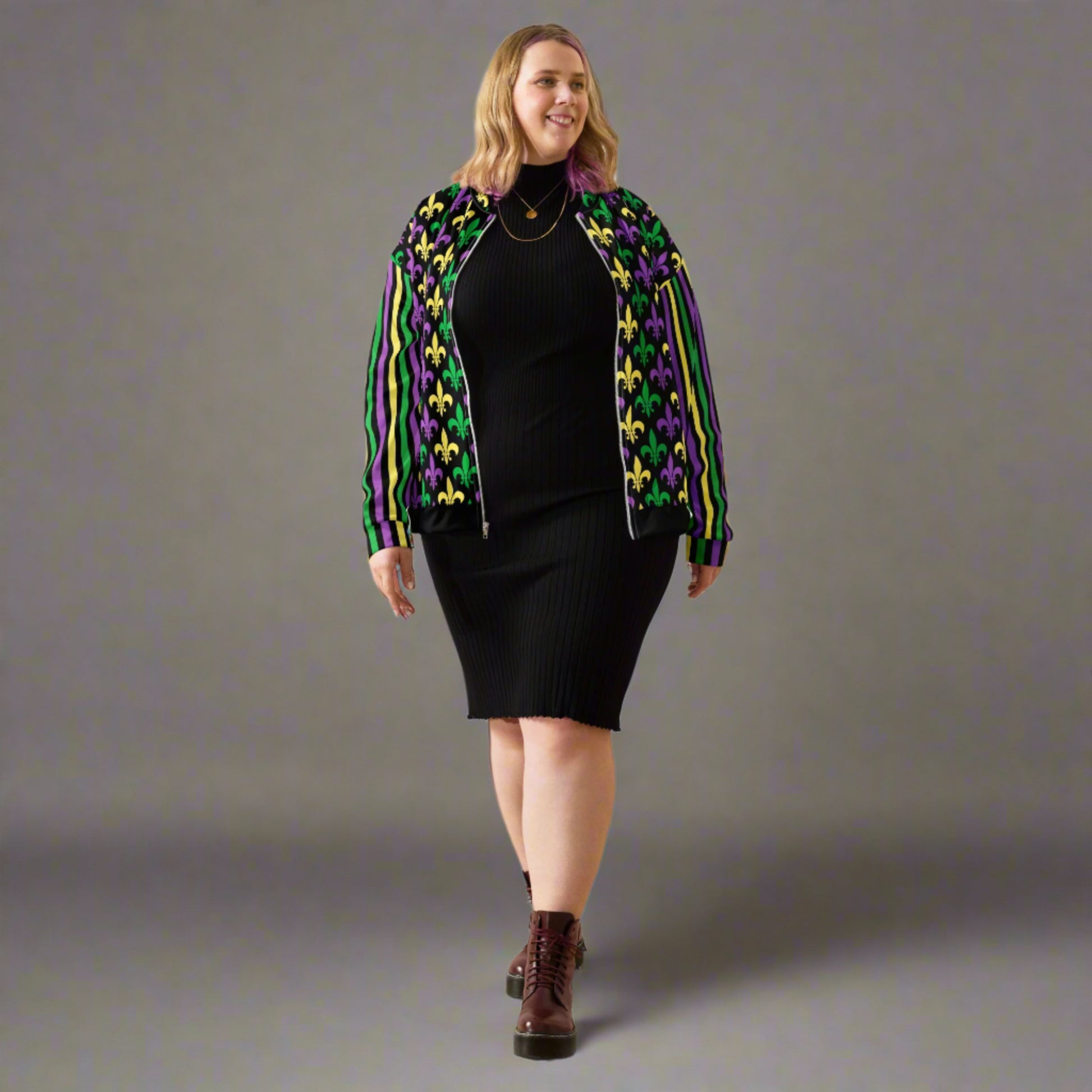 Image: Mardi Gras Unisex Bomber Jacket. This lightweight NOLA apparel is perfect for parades in the French Quarter, or Mardi Gras themed fun runs. It features a gold, green and purple fleur de lis pattern on the front and back, with gold, purple and green stripes going down each arm. Plus sizes available, by jaecrece