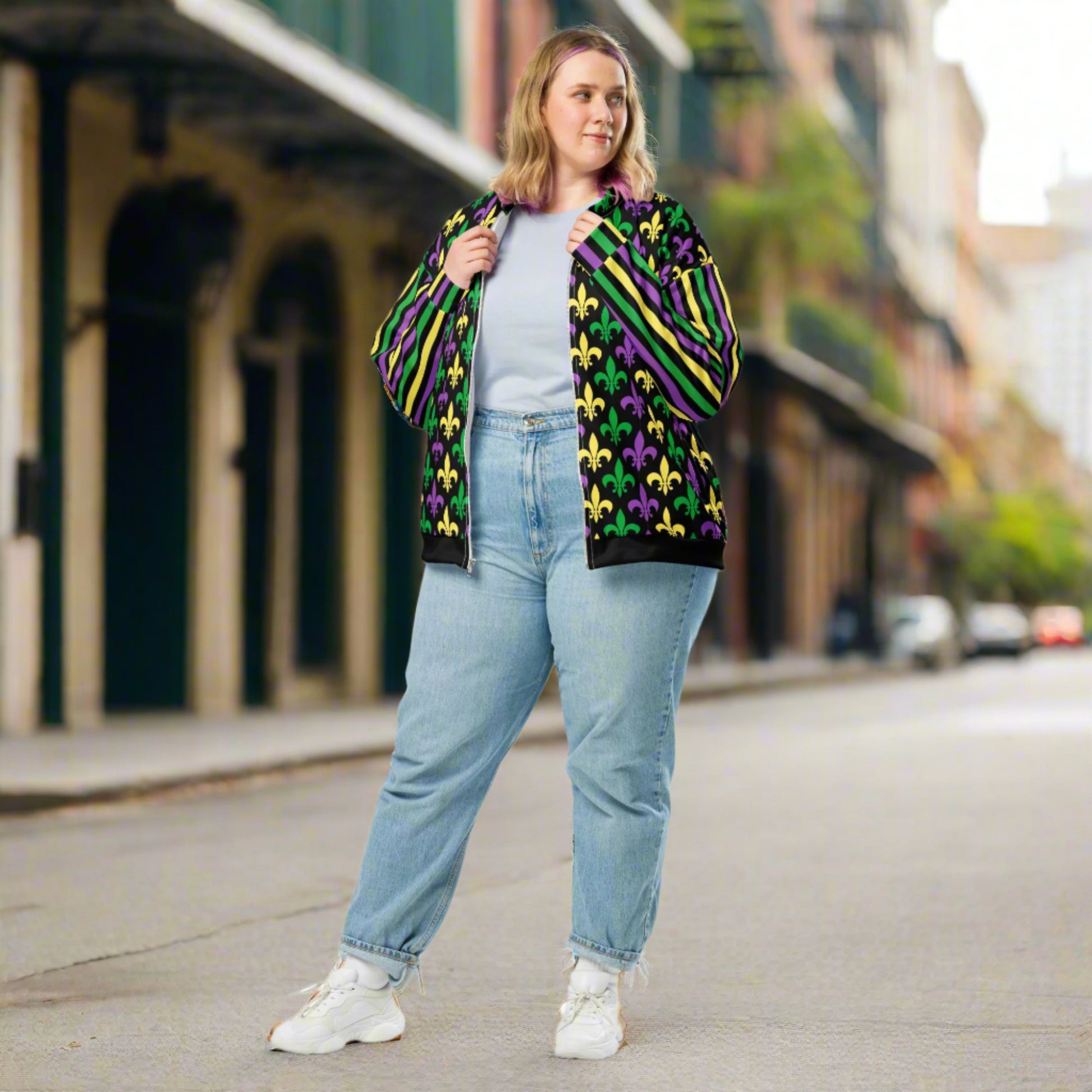 Image: Mardi Gras Unisex Bomber Jacket. This lightweight NOLA apparel is perfect for parades in the French Quarter, or Mardi Gras themed fun runs. It features a gold, green and purple fleur de lis pattern on the front and back, with gold, purple and green stripes going down each arm. Plus sizes available, by jaecrece