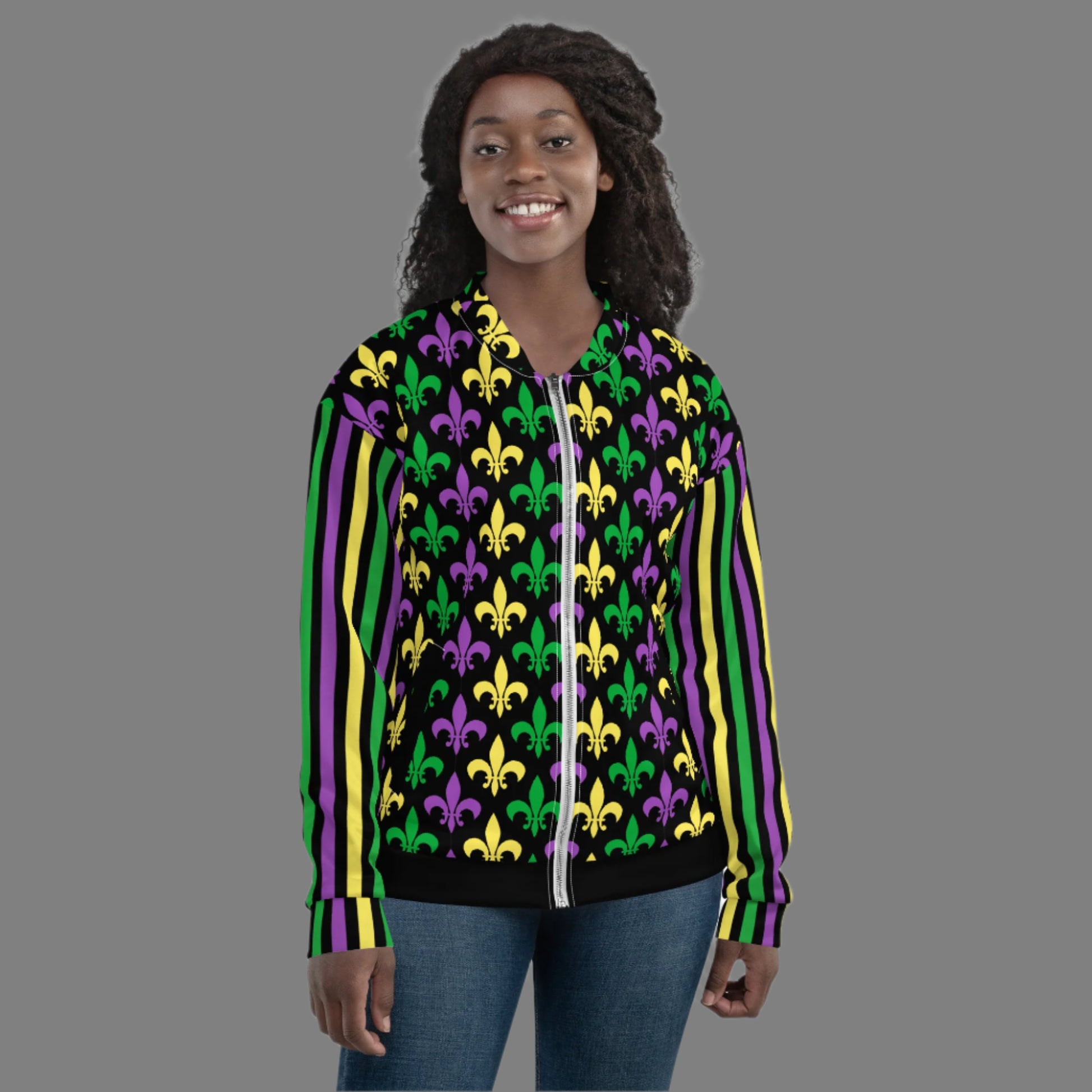 Image: Mardi Gras Unisex Bomber Jacket. This lightweight NOLA apparel is perfect for parades in the French Quarter, or Mardi Gras themed fun runs. It features a gold, green and purple fleur de lis pattern on the front and back, with gold, purple and green stripes going down each arm. Plus sizes available, by jaecrece