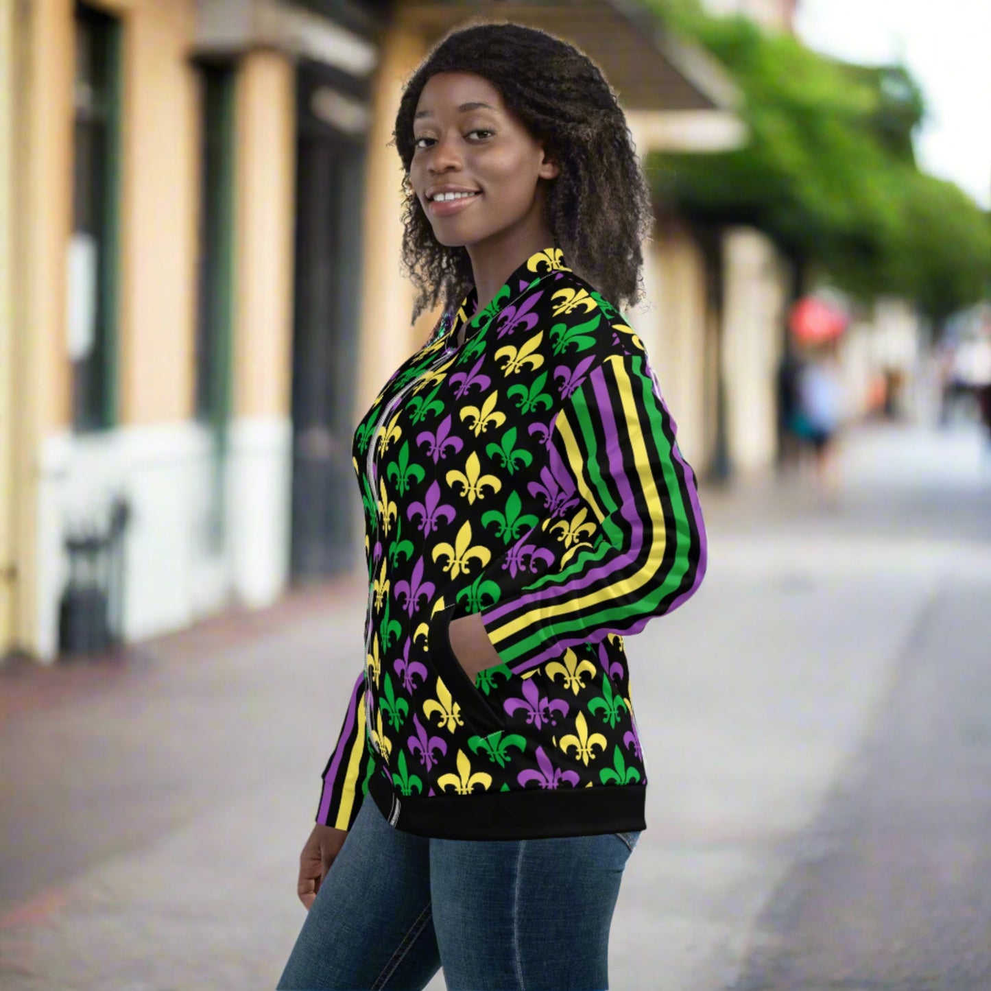 Image: Mardi Gras Unisex Bomber Jacket. This lightweight NOLA apparel is perfect for parades in the French Quarter, or Mardi Gras themed fun runs. It features a gold, green and purple fleur de lis pattern on the front and back, with gold, purple and green stripes going down each arm. Plus sizes available, by jaecrece