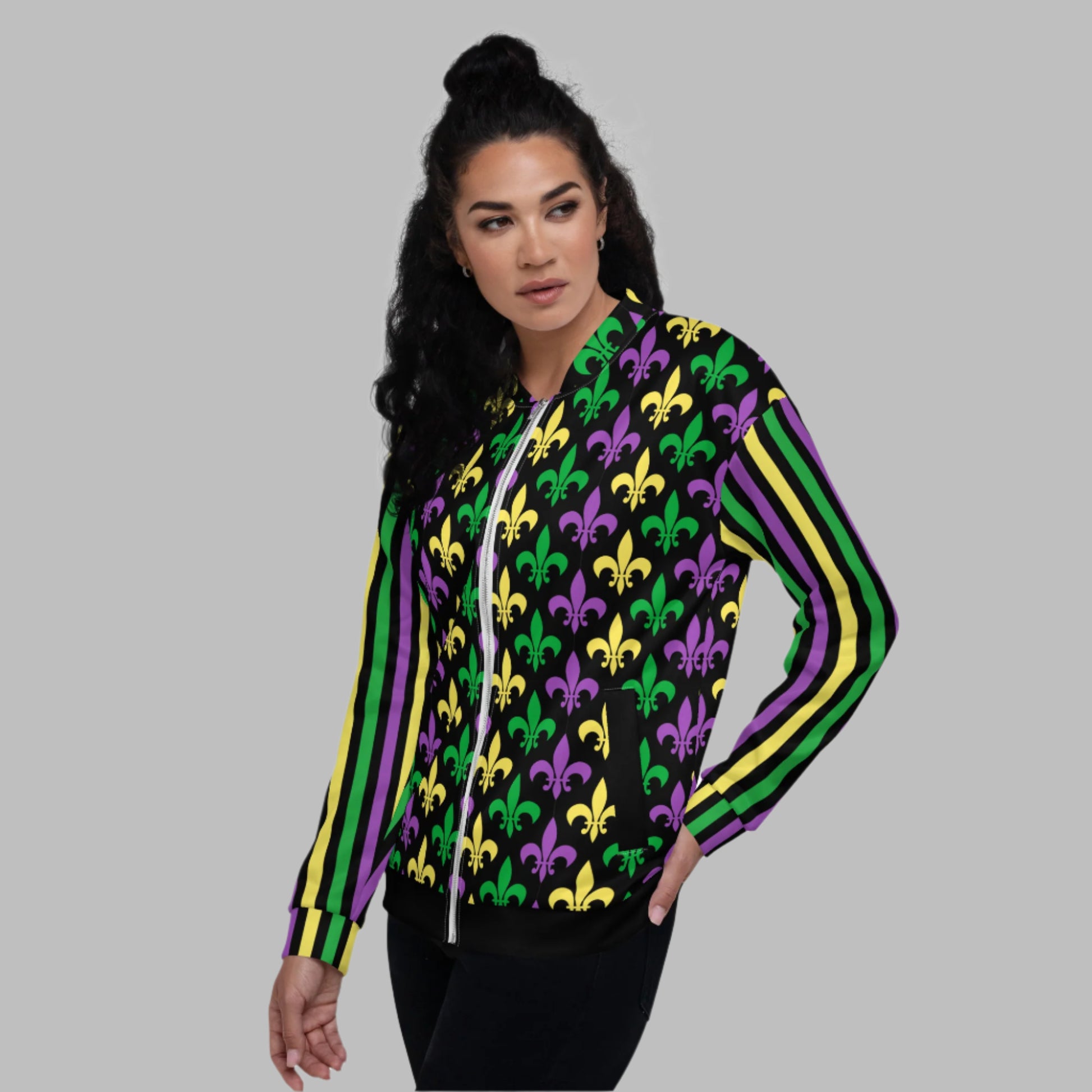 Image: Mardi Gras Unisex Bomber Jacket. This lightweight NOLA apparel is perfect for parades in the French Quarter, or Mardi Gras themed fun runs. It features a gold, green and purple fleur de lis pattern on the front and back, with gold, purple and green stripes going down each arm. Plus sizes available, by jaecrece