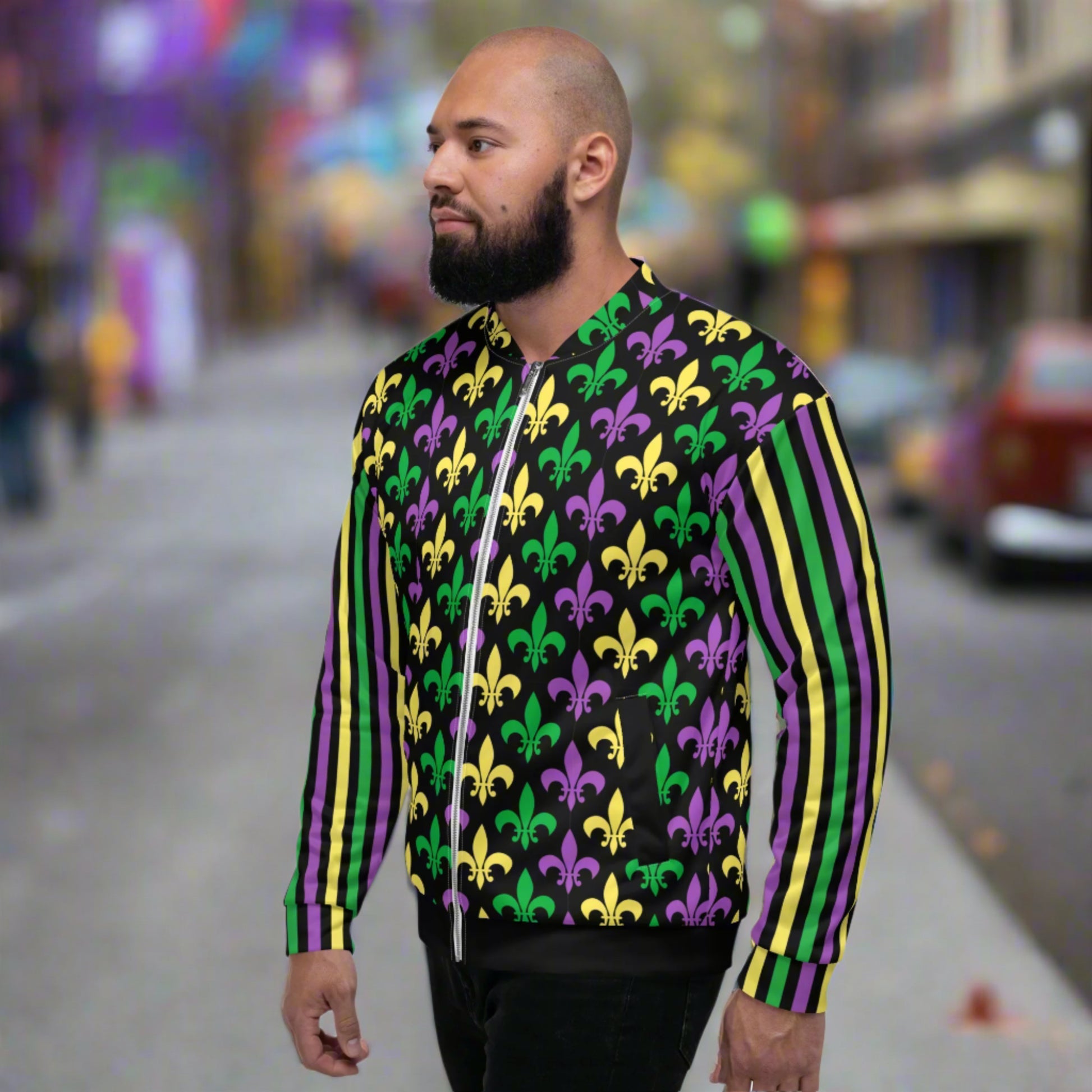 Image: Mardi Gras Unisex Bomber Jacket. This lightweight NOLA apparel is perfect for parades in the French Quarter, or Mardi Gras themed fun runs. It features a gold, green and purple fleur de lis pattern on the front and back, with gold, purple and green stripes going down each arm. Plus sizes available, by jaecrece