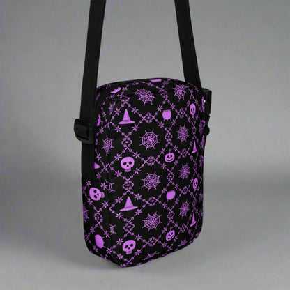 Our Wickedly Cute Halloween Crossbody Utility Bag is made with black water resistant canvas, and features an adorable Halloween themed purple pattern of spider webs, skulls, witch hats and pumpkins. These make a perfect gift for adults, teens and tweens. by jaecrece.com