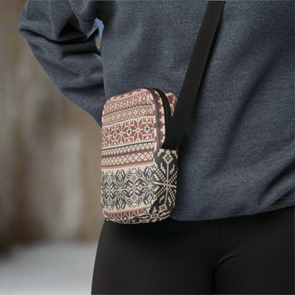 Image: Fair Isle Crossbody Bag. This small canvas tote has a Scandanavian geometric pattern of snowflakes in maroon and navy blue. It may be worn across the hips, waist, chest or as a mini backpack, by jaecrece