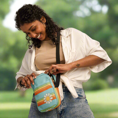 Rainbow & Daisy Canvas Utility Crossbody bag is light blue, with a retro rainbow and daisy pattern. With two storage pockets and a two way zipper, this small tote is perfect for adventures, by jaecrece