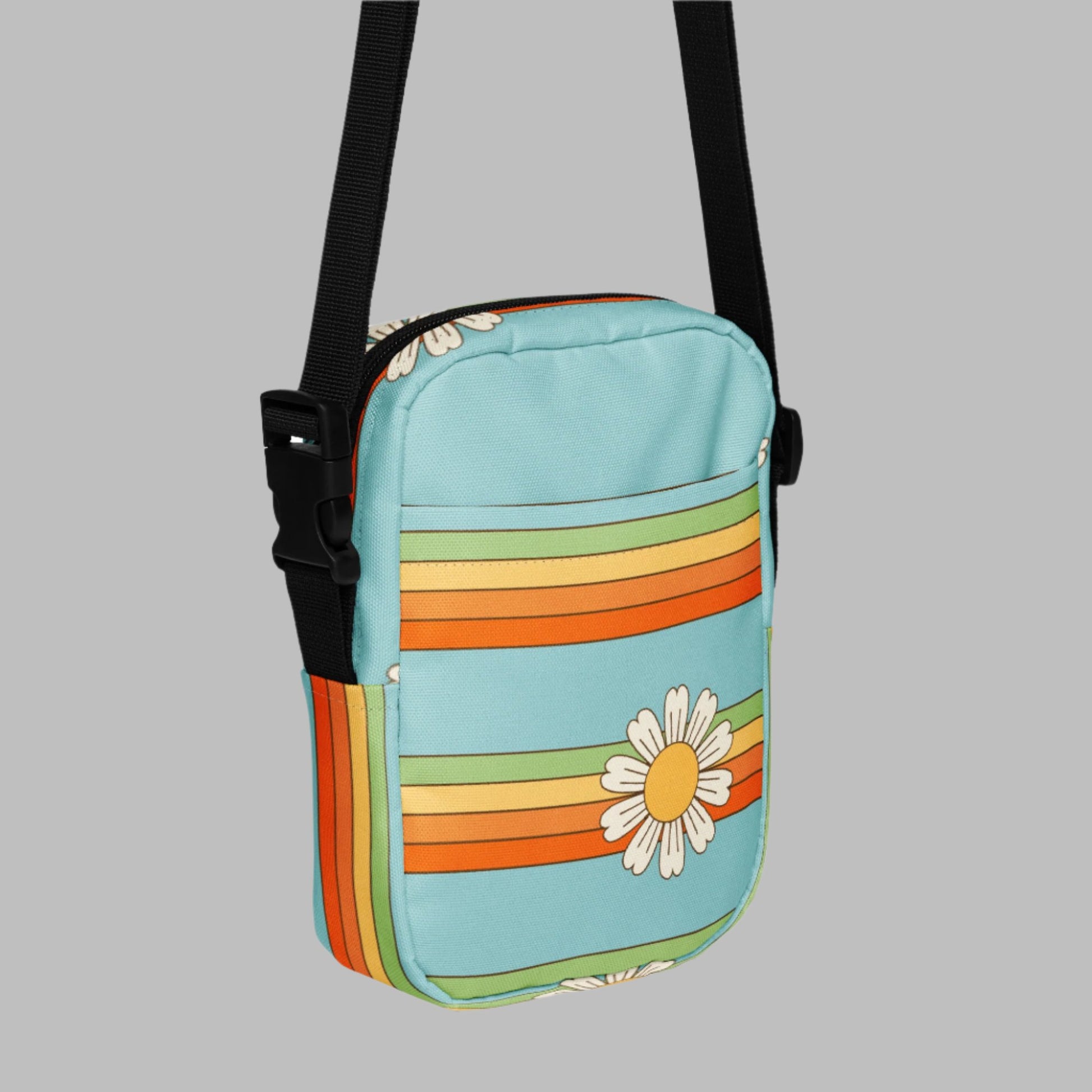 Rainbow & Daisy Canvas Utility Crossbody bag is light blue, with a retro rainbow and daisy pattern. With two storage pockets and a two way zipper, this small tote is perfect for adventures, by jaecrece