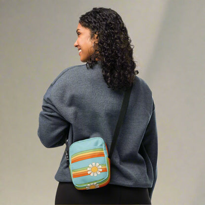 Rainbow & Daisy Canvas Utility Crossbody bag is light blue, with a retro rainbow and daisy pattern. With two storage pockets and a two way zipper, this small tote is perfect for adventures, by jaecrece