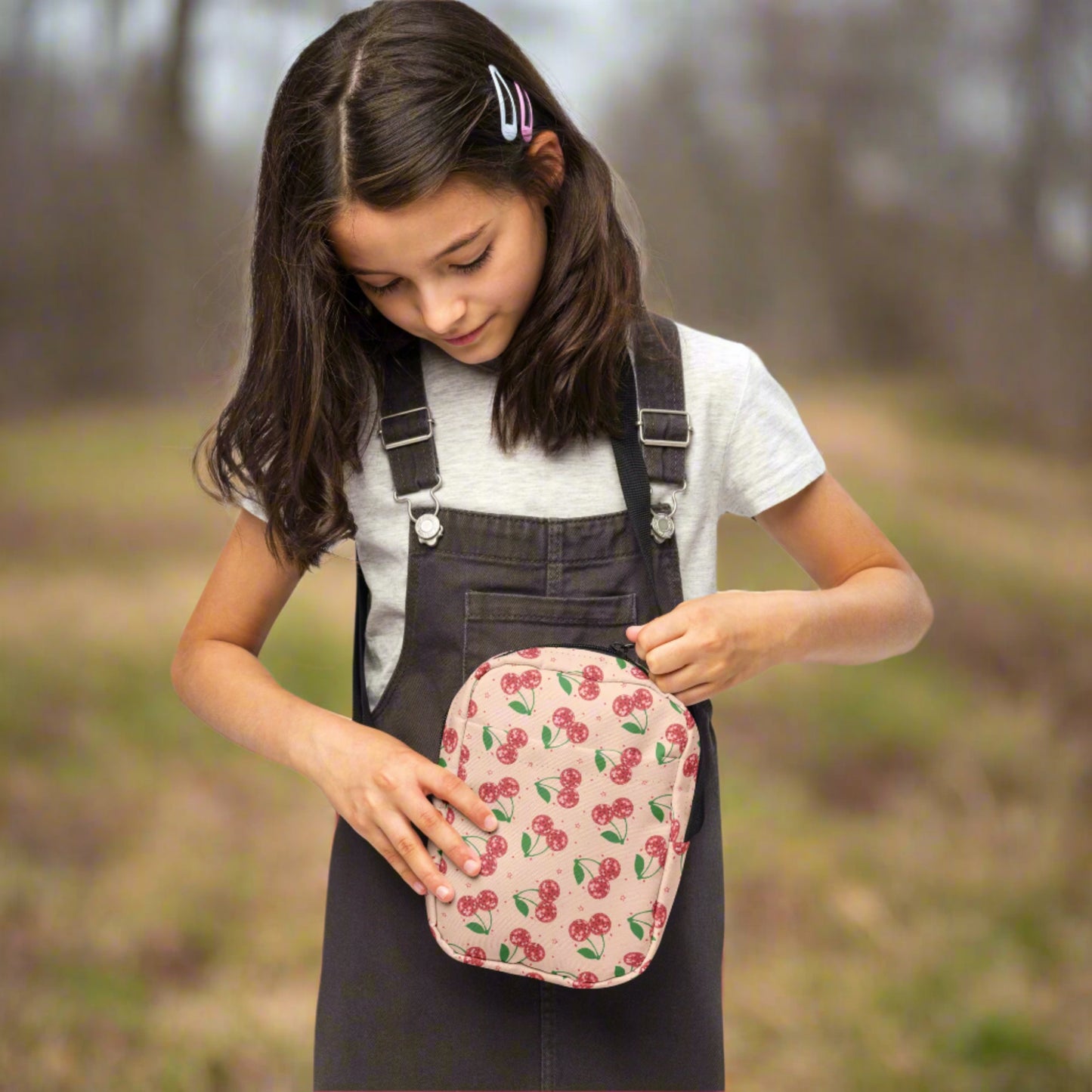 Image: Pink Utility Crossbody bag with a pattern of red disco ball cherries and stars. A great small tote to be worn across the chest, hips, waist. Perfect  as a Valentines Day gift or for outdoor activities, such as parades, hiking or the amusement park, by jaecrece