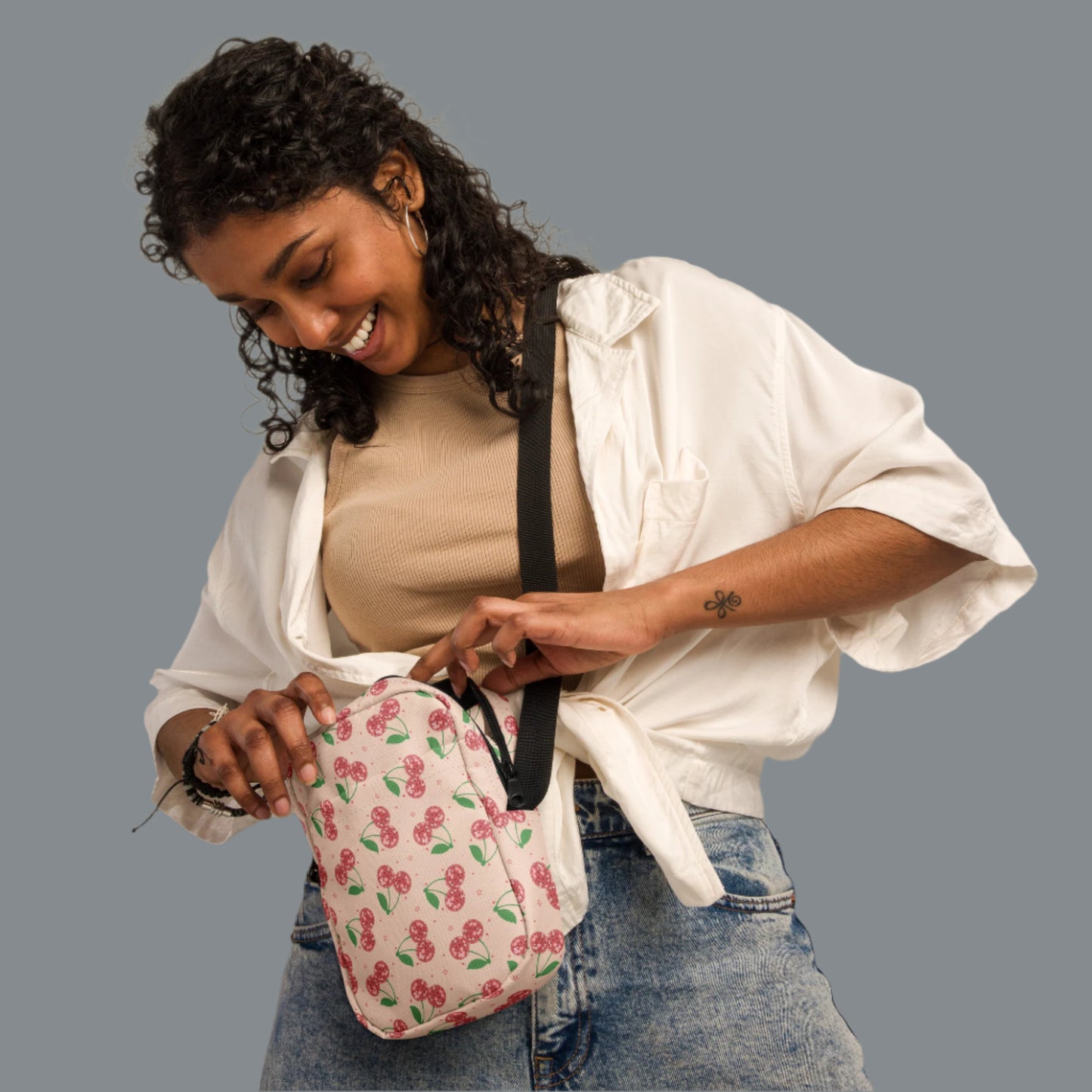 Image: Pink Utility Crossbody bag with a pattern of red disco ball cherries and stars. A great small tote to be worn across the chest, hips, waist. Perfect  as a Valentines Day gift or for outdoor activities, such as parades, hiking or the amusement park, by jaecrece