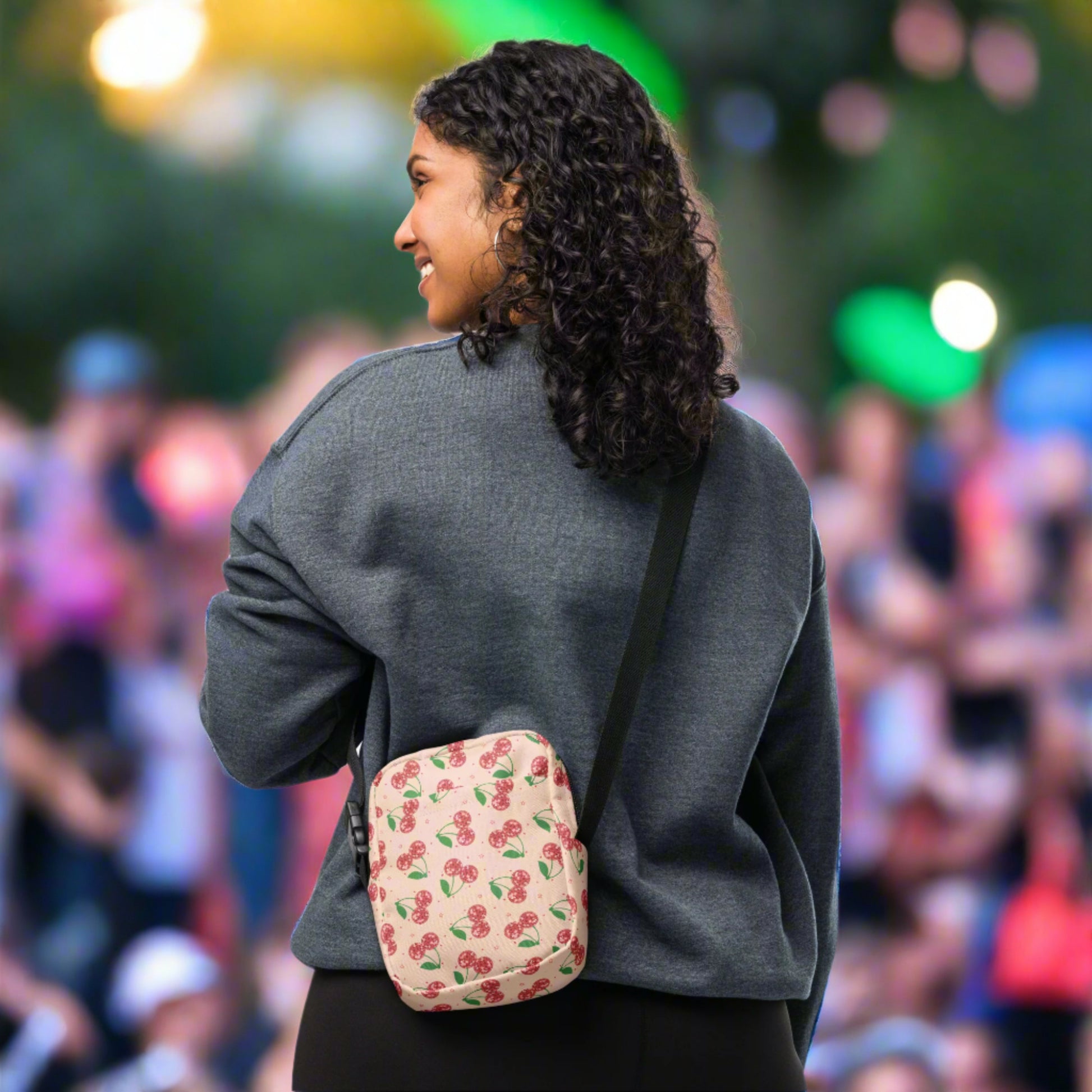 Image: Pink Utility Crossbody bag with a pattern of red disco ball cherries and stars. A great small tote to be worn across the chest, hips, waist. Perfect  as a Valentines Day gift or for outdoor activities, such as parades, hiking or the amusement park, by jaecrece