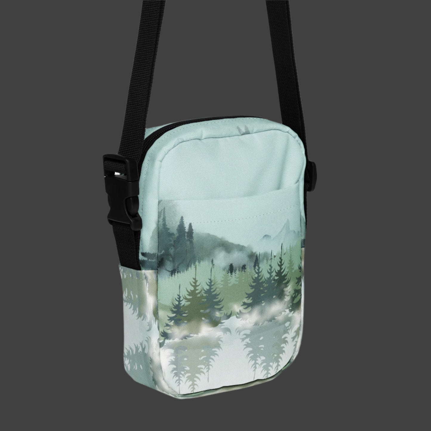 Image: Winter Forest Small Cross Body Bag. This nature inspired sling bag has an ombre snowy mountain print that fades from a blue gray sky to mountains and pine trees to white snow. This mini backpack has a zipper closure and two storage pockets for hands free outdoor adventures. Great for tween girls, teens and ladies, by jaecrece