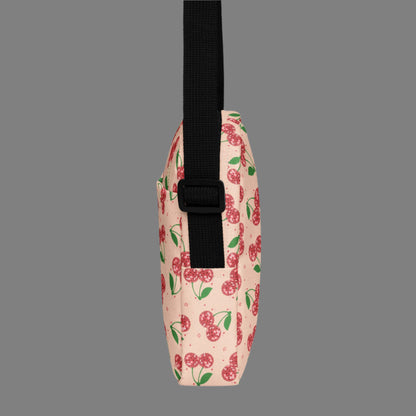 Image: Pink Utility Crossbody bag with a pattern of red disco ball cherries and stars. A great small tote to be worn across the chest, hips, waist. Perfect  as a Valentines Day gift or for outdoor activities, such as parades, hiking or the amusement park, by jaecrece