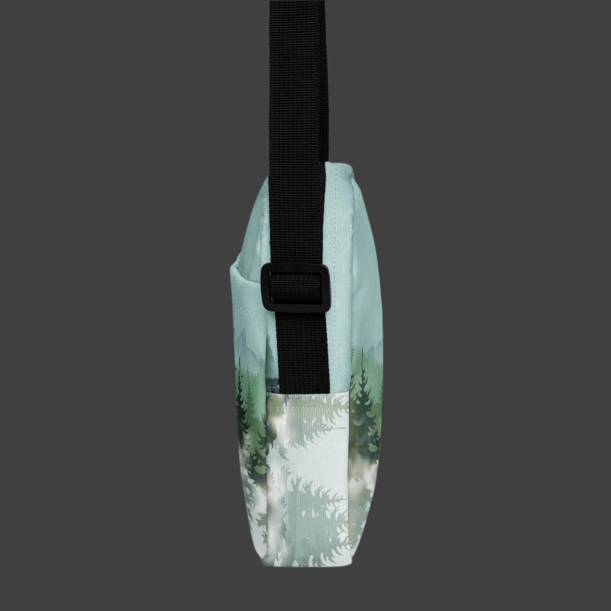 Image: Winter Forest Small Cross Body Bag. This nature inspired sling bag has an ombre snowy mountain print that fades from a blue gray sky to mountains and pine trees to white snow. This mini backpack has a zipper closure and two storage pockets for hands free outdoor adventures. Great for tween girls, teens and ladies, by jaecrece