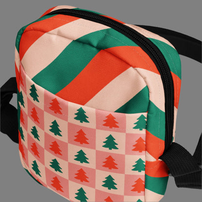 Our red and pink christmas tree utility crossbody bag has a pink and red checker pattern with xmas trees on the front and back. The sides of this small canvas tote are red, pink and green candy cane stripes. This mini backpack is perfect for parades, hiking, biking or anywhere you need to be hands free. Makes a great holiday gift for girls, moms, teens or tweens, by jaecrece