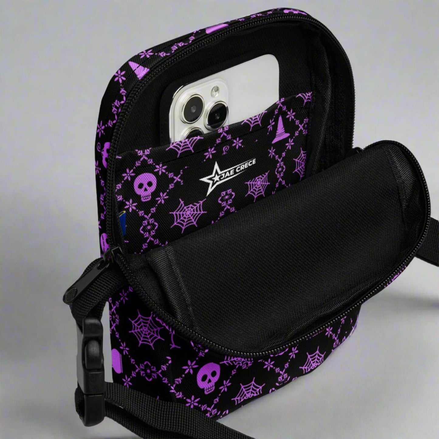 Our Wickedly Cute Halloween Crossbody Utility Bag is made with black water resistant canvas, and features an adorable Halloween themed purple pattern of spider webs, skulls, witch hats and pumpkins. These make a perfect gift for adults, teens and tweens. by jaecrece.com