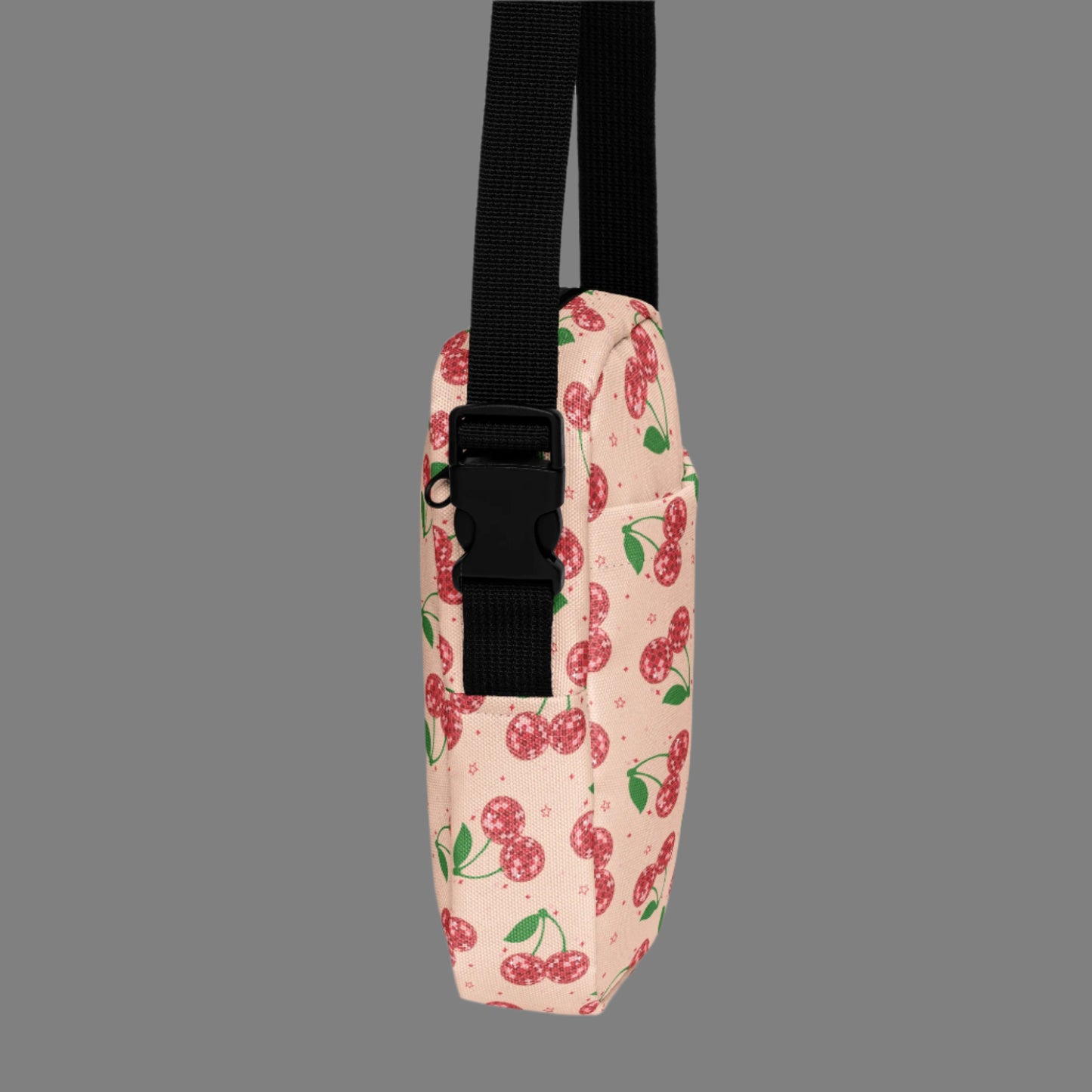 Image: Pink Utility Crossbody bag with a pattern of red disco ball cherries and stars. A great small tote to be worn across the chest, hips, waist. Perfect  as a Valentines Day gift or for outdoor activities, such as parades, hiking or the amusement park, by jaecrece