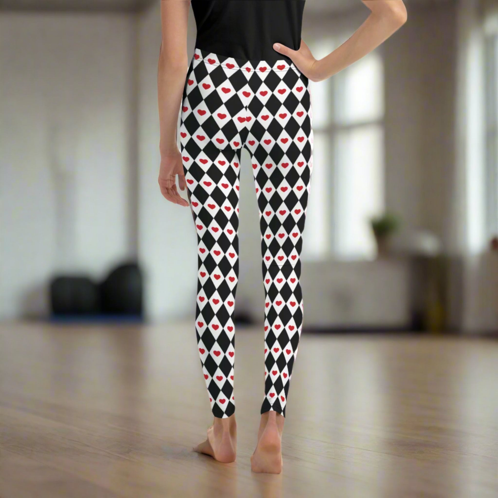 Image: Black and white harlequin check youth leggings with red heart accents. These yoga pants are designed for comfort and flexibility, by jaecrece