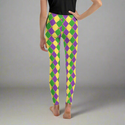 image: Youth girls harlequin diamond or checkerboard pattern leggings in purple, green and gold, with a repeating Fleur de Lis pattern, by jaecrece
Mardi Gras Leggings, Fat Tuesday Tights, teen Parade Outfit, Yoga Workout Pants, Mommy Me Match, New Orleans Tween Girl NOLA Costume