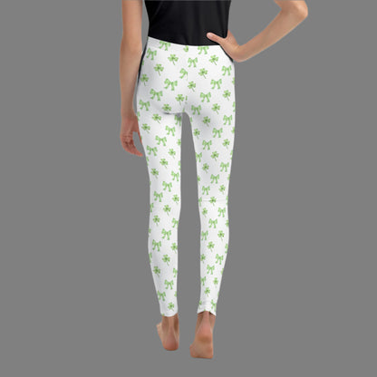 Image: St Patricks Day Leggings for toddlers, girls, tween and women. These white coquette yoga pants feature a dainty pattern of shamrocks and bows, by jaecrece