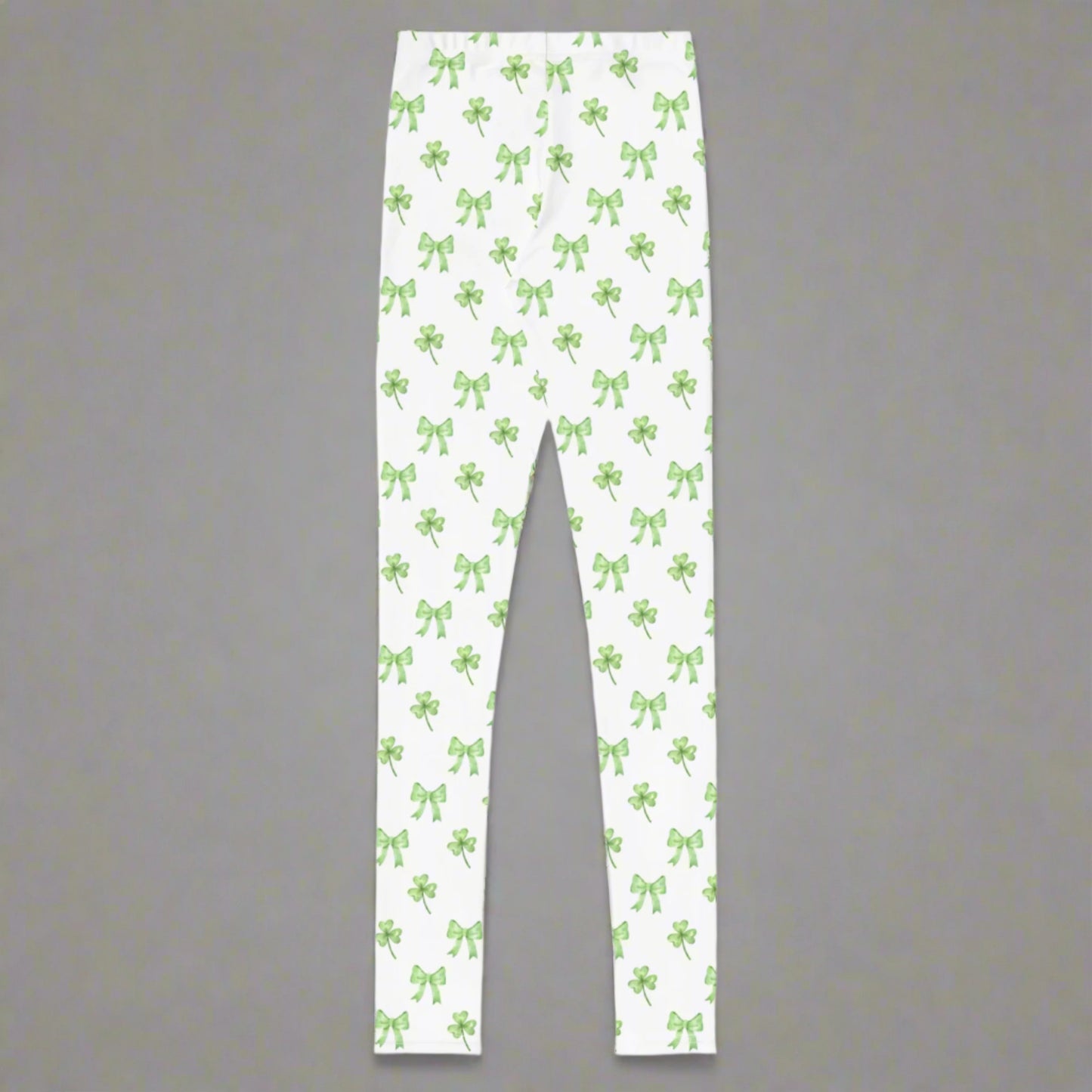 Image: St Patricks Day Leggings for toddlers, girls, tween and women. These white coquette yoga pants feature a dainty pattern of shamrocks and bows, by jaecrece