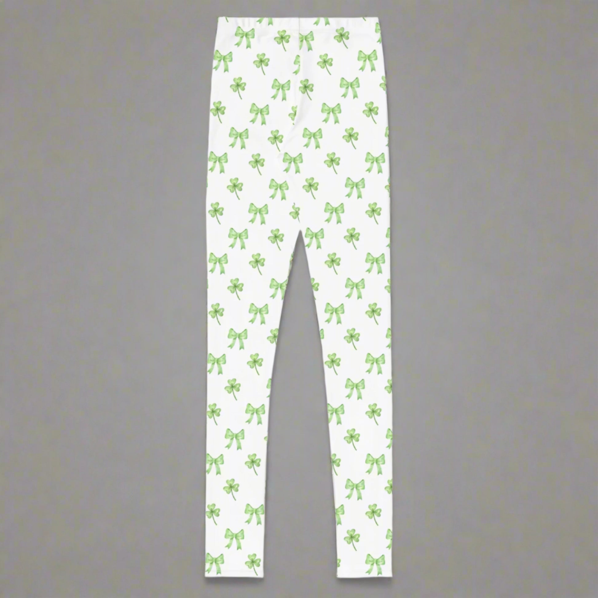 Image: St Patricks Day Leggings for toddlers, girls, tween and women. These white coquette yoga pants feature a dainty pattern of shamrocks and bows, by jaecrece