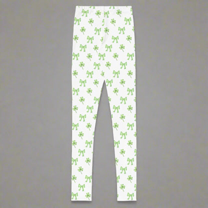 Image: St Patricks Day Leggings for toddlers, girls, tween and women. These white coquette yoga pants feature a dainty pattern of shamrocks and bows, by jaecrece