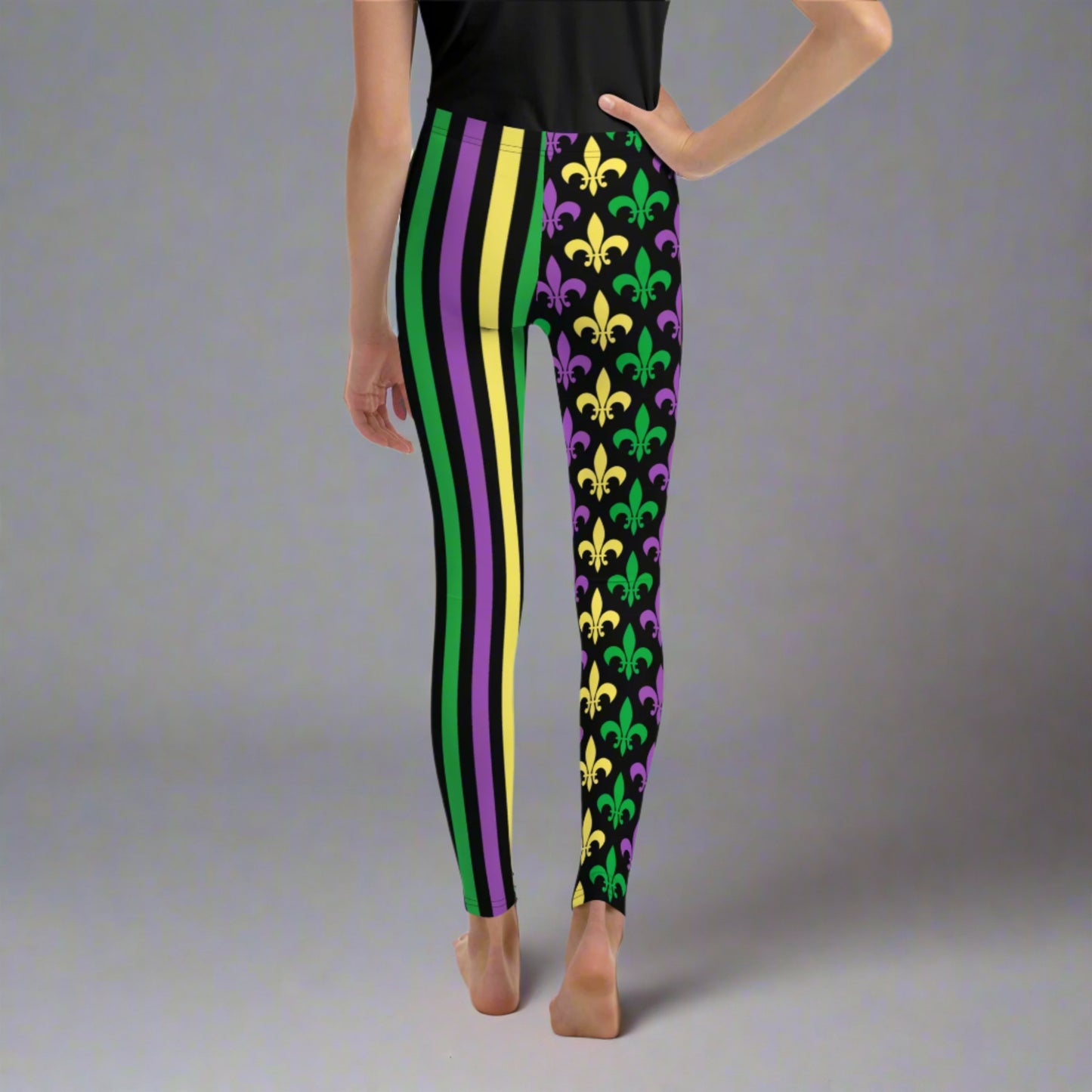 Alt text: "Mardi Gras Stripes and Fleur de Lis Youth Leggings, size 8-20. Black leggings with a fleur de lis pattern on one leg and bright green, purple, and yellow stripes on the other. Elastic, soft, and durable with vibrant colors. Part of a matching collection for younger children and women, each pair is precision-cut and hand-sewn for a perfect fit."