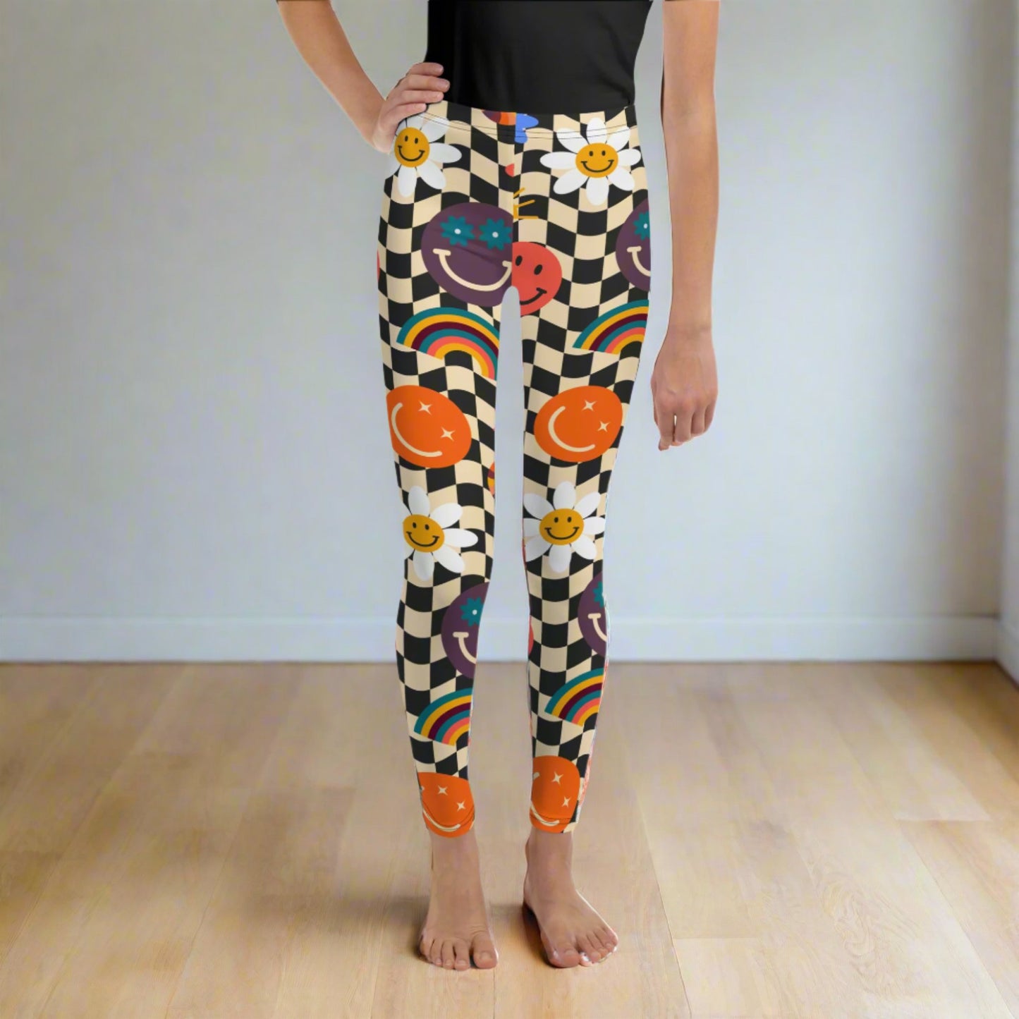 Image: Retro Checkerboard Girls Leggings, in size 8-20. These yoga pants feature a black and khaki vintage check pattern with smiley faces, daisies, rainbows and suns. These vintage tights make a great birthday present, birthday gift, and are great for back to school, by jaecrece