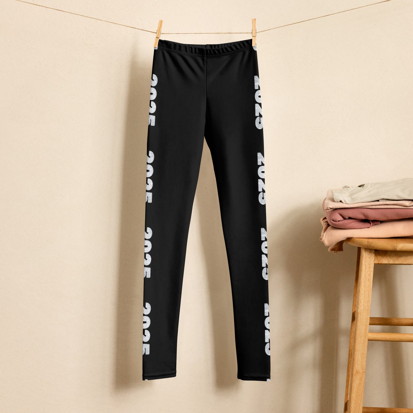 2025 Leggings for Happy New Year Party Celebration or a gift for graduating class of 2025. Black yoga pants have large repeating silver 2025 running down the outside of each leg. Tights are available in youth, tween, teen sizes 8-20, by jaecrece